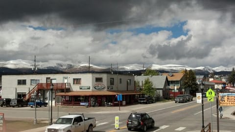 Across the street is the sporting goods store and mountains in the distance