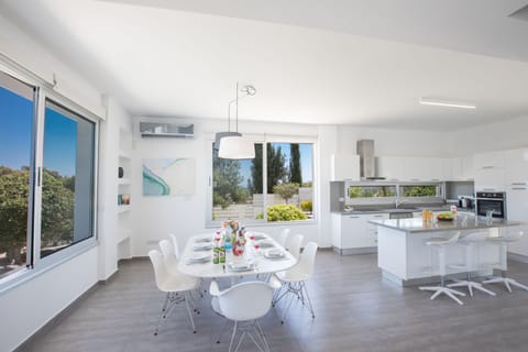 Kitchen and dining area with table and chairs to seat 8 people