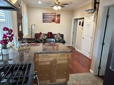 View of living space from the kitchen. Bedroom entry from kitchen on the right.
