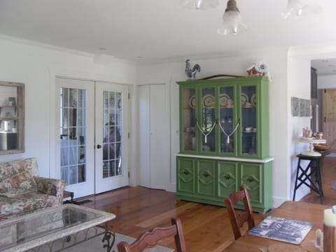 Antique glassed cabinet and french doors to the screened in porch