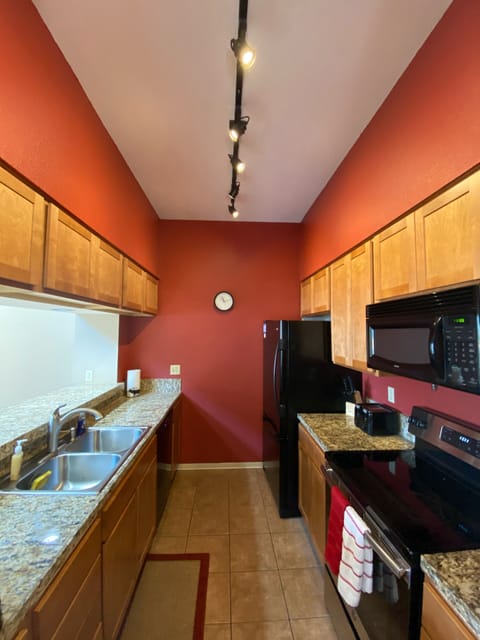 Well equipped kitchen with granite countertops