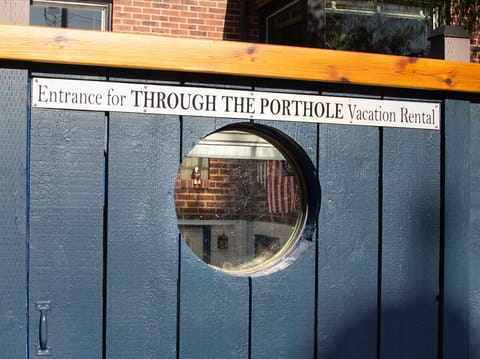 LOOK "through the porthole" WALK through the large gate. Doesn't work otherwise.
