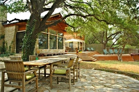 Large Deck/Seating area to the rear of the home. Large Tree Covered Stone Patio