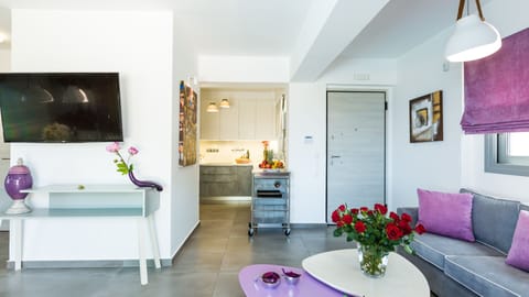 Living room area and kitchen next to it