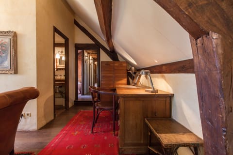 Desk on the mezzanine of the main house with its Chesterfield sofa in old leather and upholstery