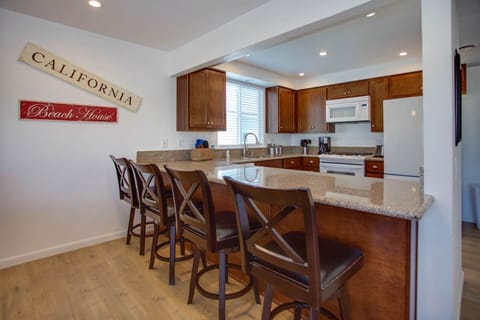 Breakfast bar seating overlooks kitchen headquarters.