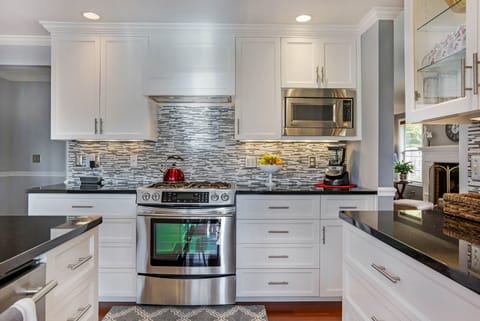 This fully furnished kitchen features Jenn Air stainless steel appliances.