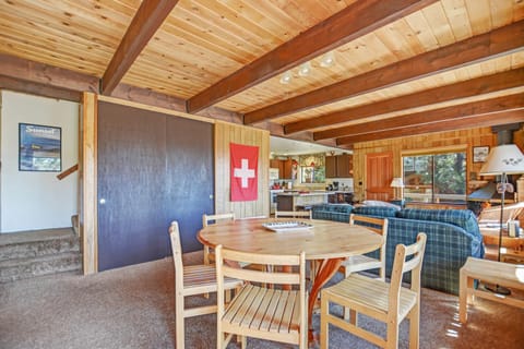 main floor view of open dining and living area with kitchen beyond