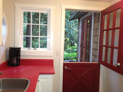 Old Dutch door opens onto your private patio beside a running stream.