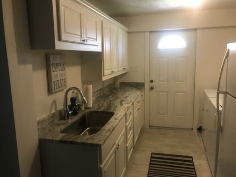 ground level washer/dryer and refrigerator.