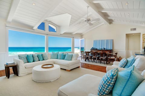 Relax and enjoy the view from the beautiful living room steps from the sand