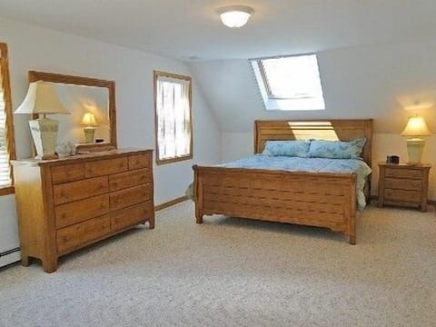 Spacious master bedroom with skylights