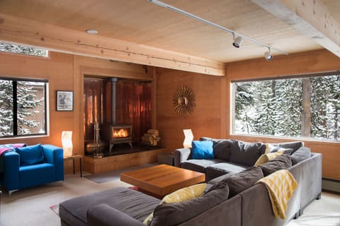 The open-plan living room/dining room with woodstove is the heart of the house