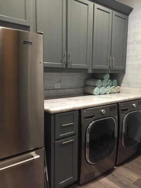 Main laundry room with additional refridgerator
