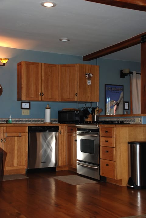 The kitchen has a full-sized dishwasher and a gas range/oven.