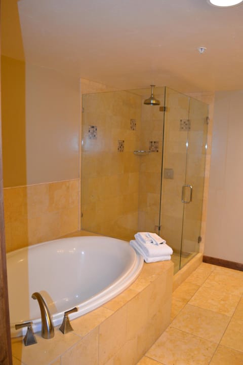First of two large master bathrooms with jacuzzi tub and rain shower head. 