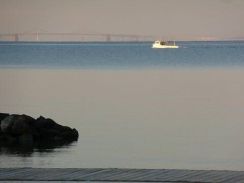 Early morning  crabbing with Bay Bridge 12 miles away over the water.