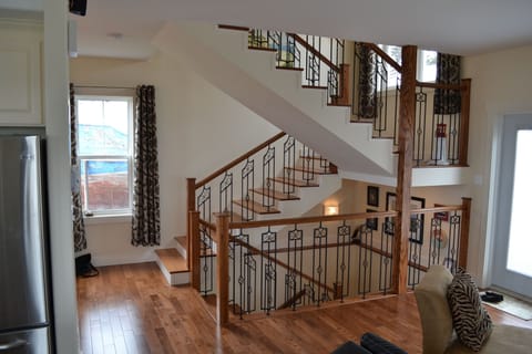 Hardwood & wrought iron main stair leading to upper and lower levels