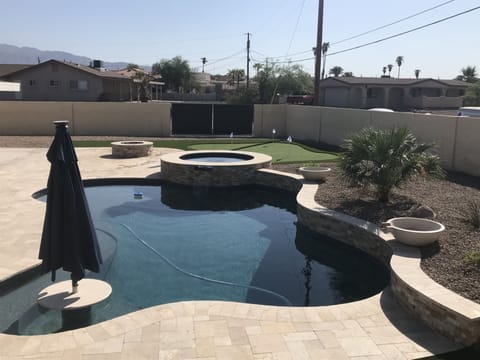 Backyard paradise with new pool, spa, firepit, and putting green.
