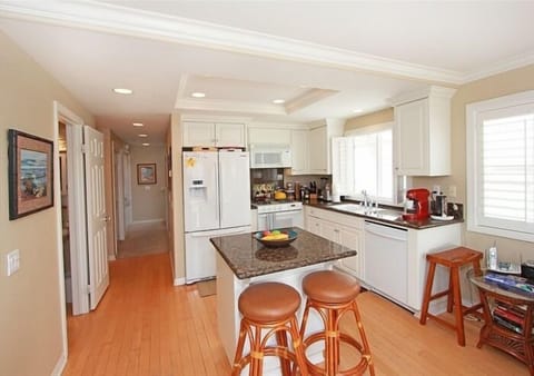 View of Kitchen w French-style double door Refrigerator, Dishwasher & hallway