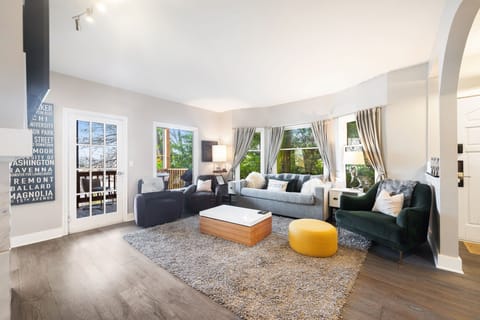 Spacious living room with pull out sofa bed and door to balcony.
