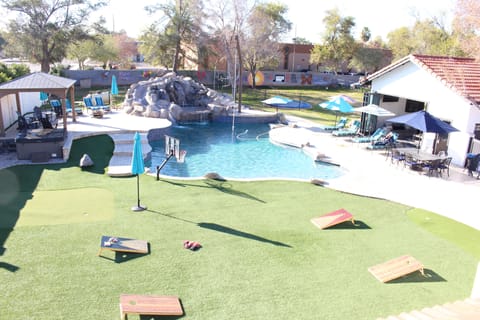 Backyard with pool house, games, diving pool, rope swing, and more