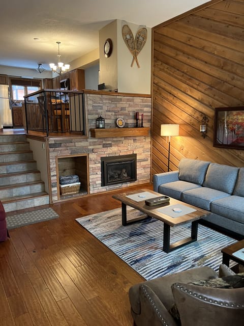 Living room with kitchen up the stairs