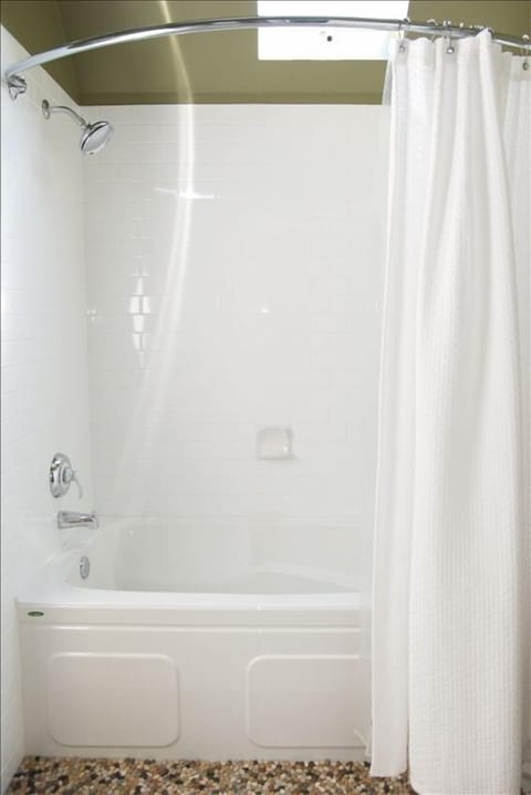 Newly renovated bathroom upstairs with deep soaker tub.