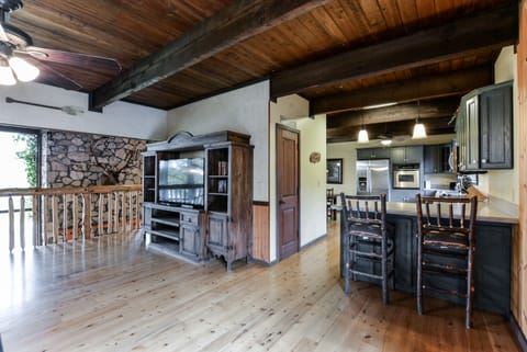 Another view of upstairs living room with the 60" Flat panel TV and the kitchen