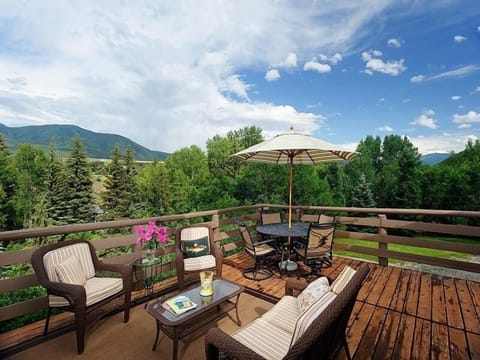 Outdoor living area overlooking river with Aspen Mountain view