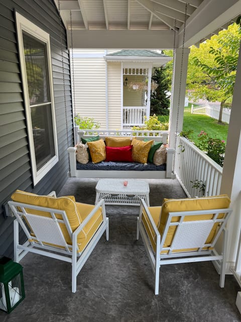 Front porch, South side, with seating for 4+ including an oversize porch swing.