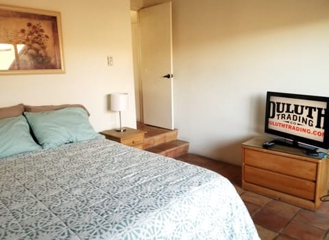 A few steps down to this Queen size bed, bedroom