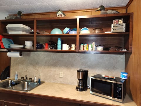 Fridge, microwave, coffee/tea maker, cookware/dishes/utensils