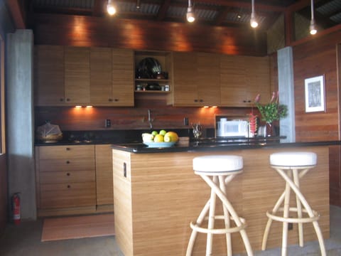 Kitchen with custom lighting fixtures made from copper plumbing pipes and parts