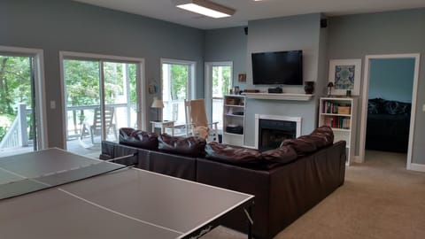 Walkout basement w/ a deck, views of the lake, family room area, & game area.