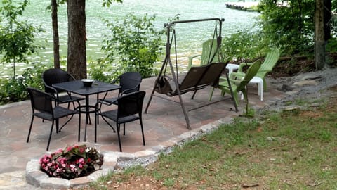 Patio next to lake and steps from the dock