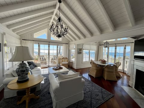 The sunny main living area offers sweeping oceanfront views