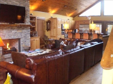 GREAT ROOM WITH HUGE ROCK FIREPLACE, 20' LEATHER SECTIONAL AND 55' FLAT PANEL