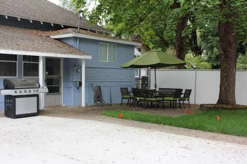 Backyard with patio table and chairs for 8 with umbrella. Gas BBQ. 
