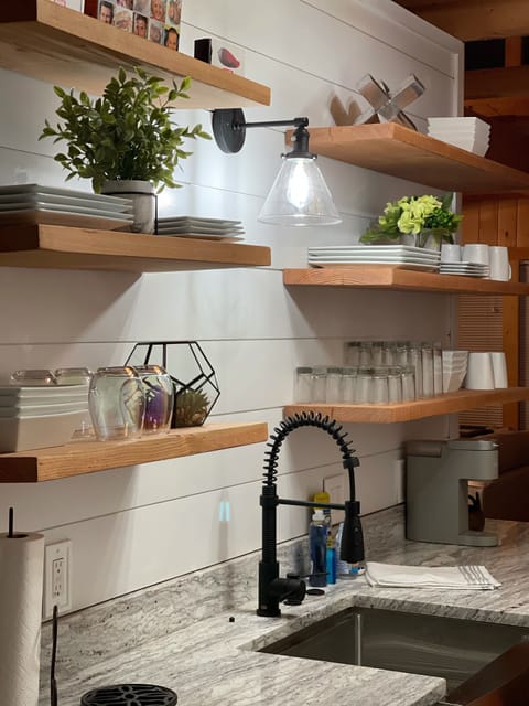 Farmhouse sink and open shelving stocked with everything you need. 