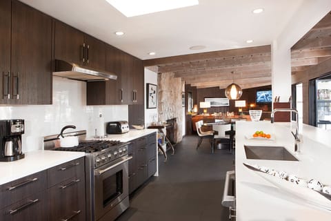 Streamlined gourmet kitchen with skylights and 3 convection ovens