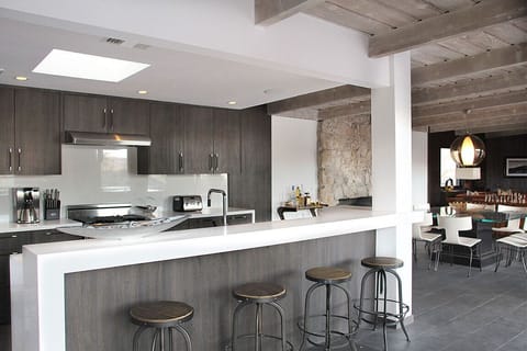 Modern gourmet kitchen featuring Electrolux appliances + Caesarstone countertops