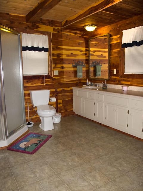Main floor bathroom includes a large countertop and full-sized washer and dryer.