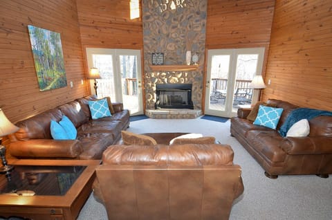 The great room with comfy leather seating, gas fire, and amazing view!