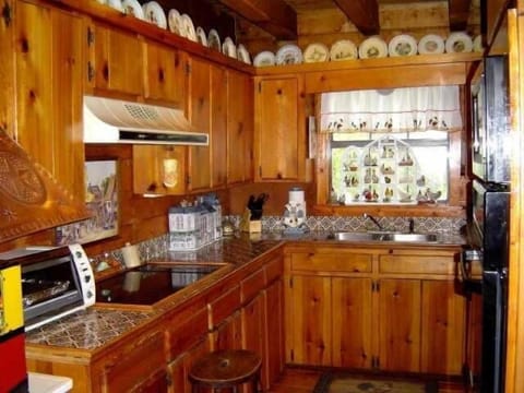 cute kitchen with mosaic tiles- has all you need for family meals