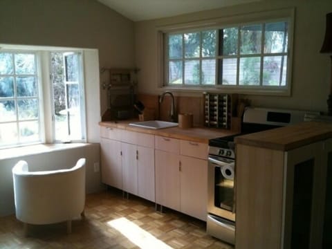 new kitchen with window access to bar and outdoor dining area