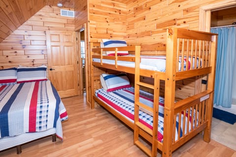 Upper level bedroom with full bathroom, queen bed and twin bunks.