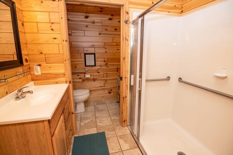 Private bathroom for BR #1 w/ zero-entry shower and toilet with strong grab bars