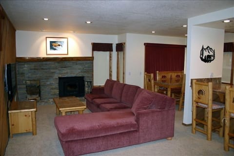 Living room with 60 inch flat screen TV & queen sofa bed, Dining room