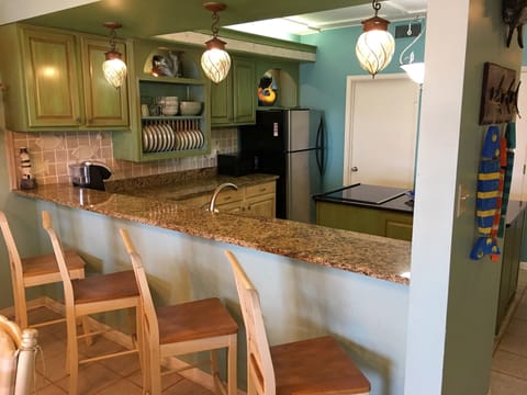 Bar seating, walk in pantry/laundry room and large center island.